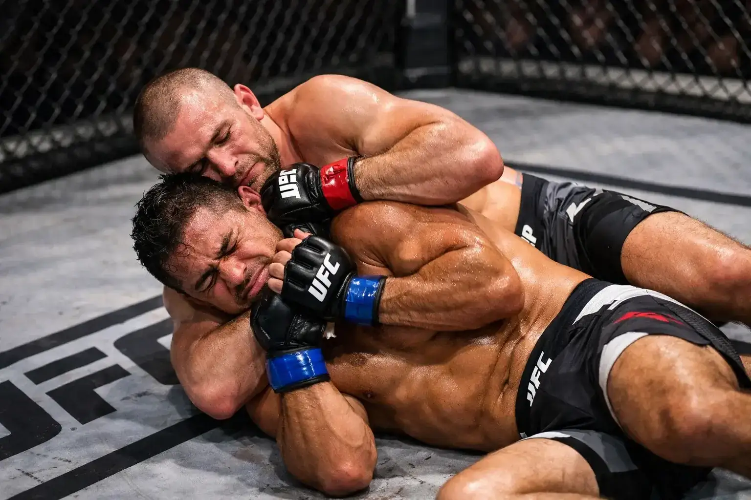 MMA fighter executing a submission hold on the ground